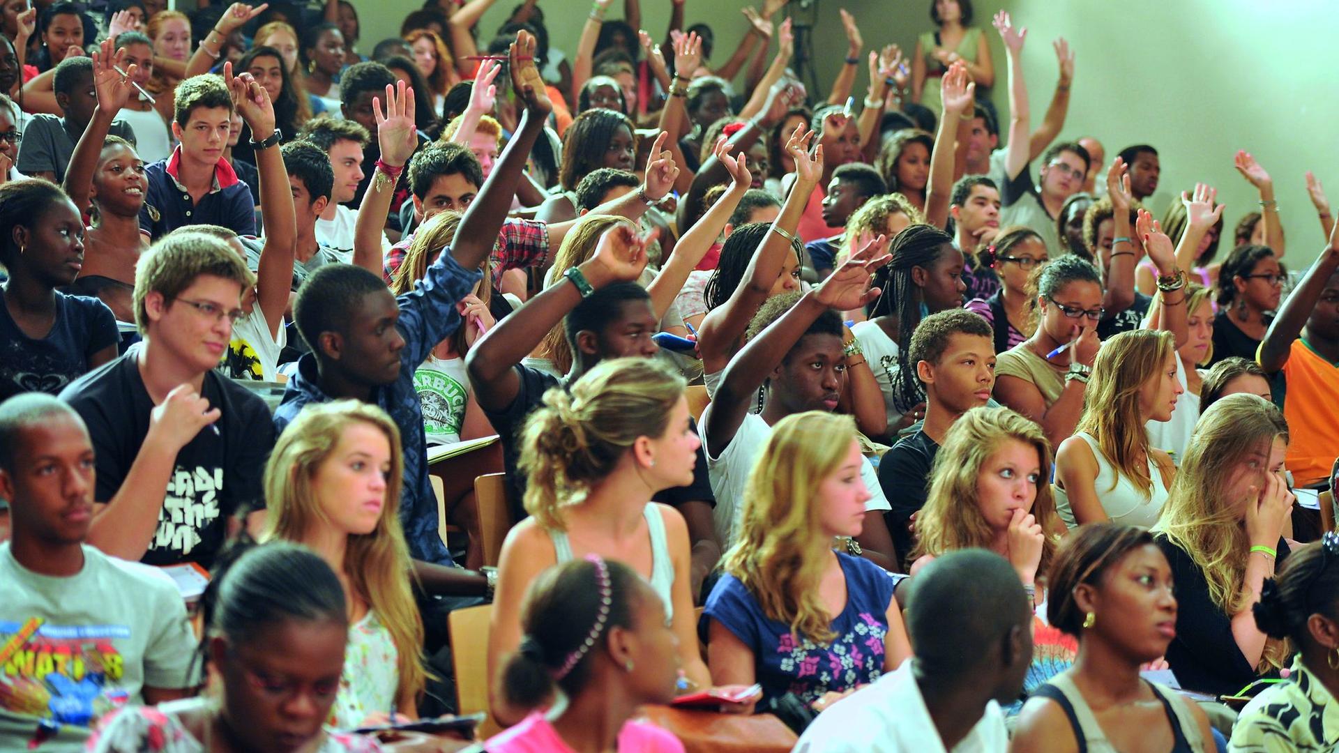 students raising hands